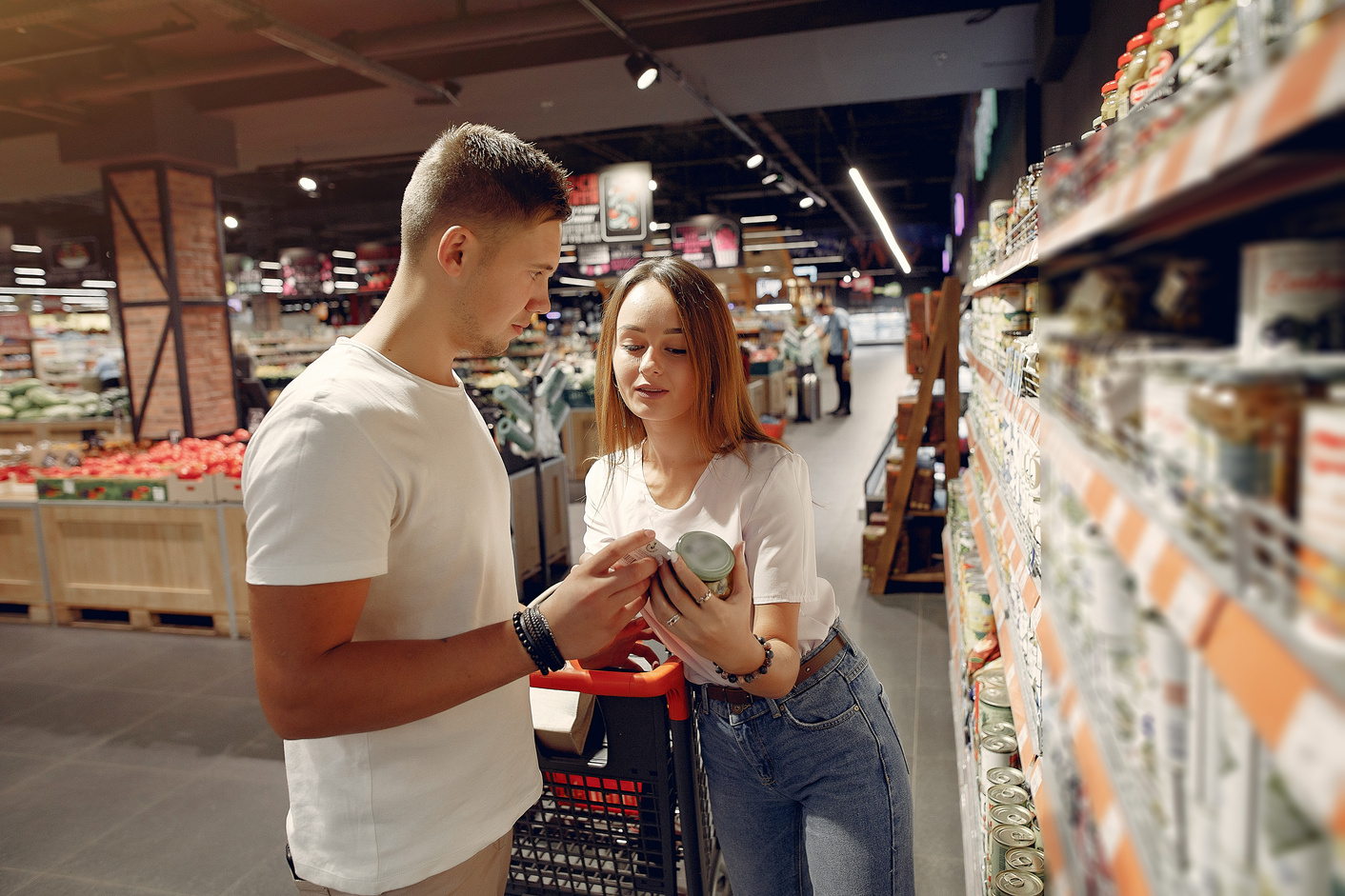 Young couple selecting food in market